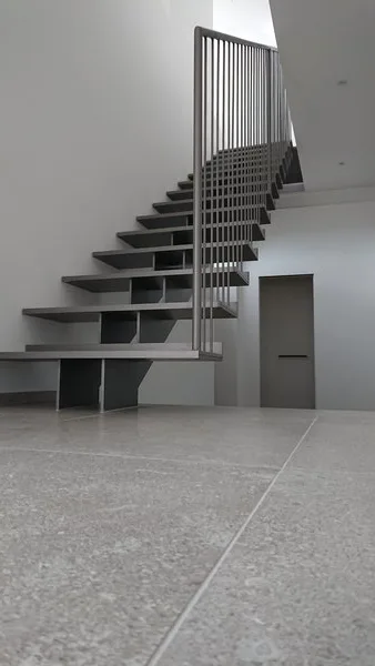 Scala a gradini sospesi con parapetto a barre verticali in un ingresso